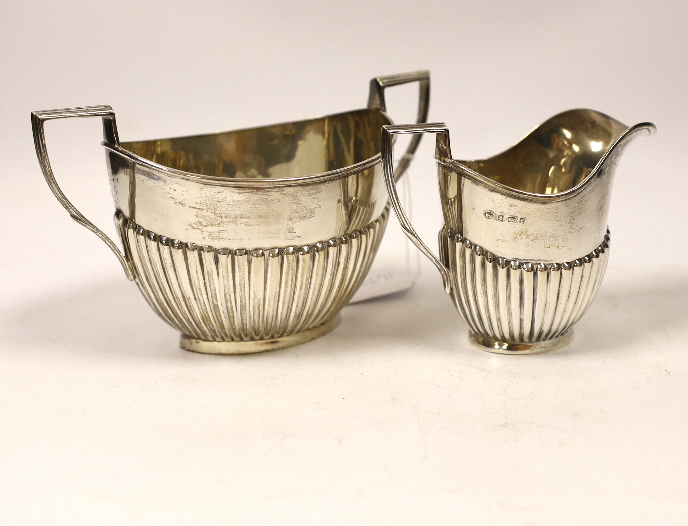 An Edwardian demi-fluted silver oval cream jug and sugar bowl, William Aitken, Birmingham, 1905